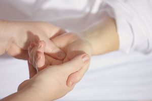 Image of touching hands during a massage