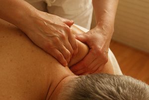 Relaxing a mans shoulders with massage treatment.