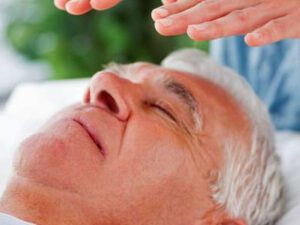 Hovering reiki healing hands over the head