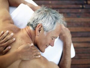 Older male client getting a back massage.
