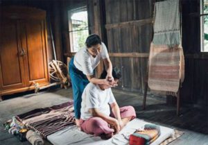Traditional Thai massage seated and fully clothed.