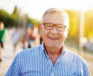 Happy older man arriving for a massage treatment