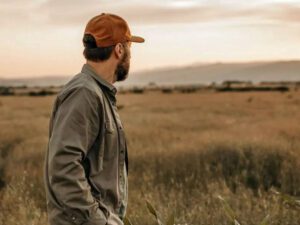 Stressed out farmer looking out over fields